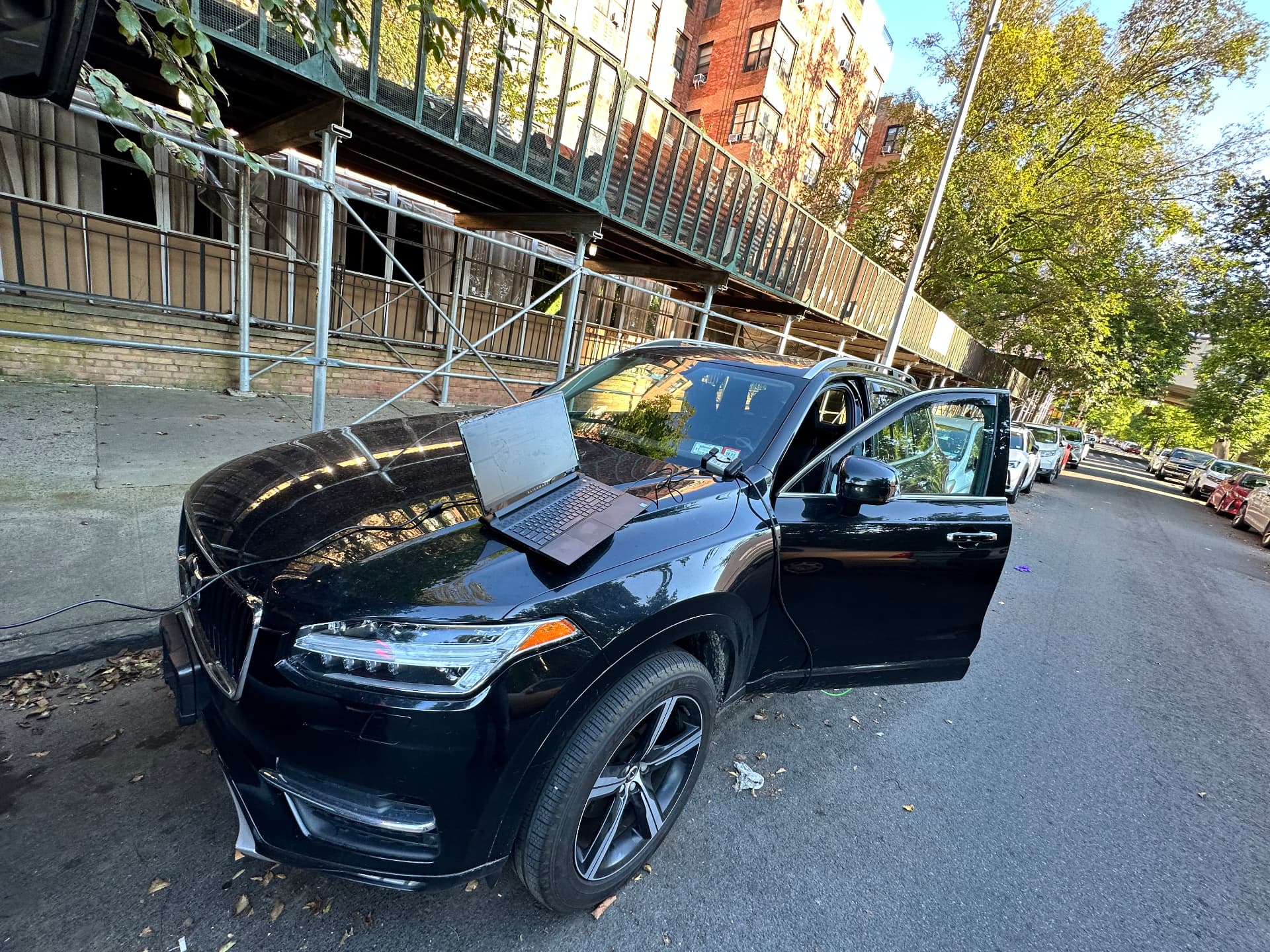 Locksmith programming a Volvo key with a laptop on a New York street